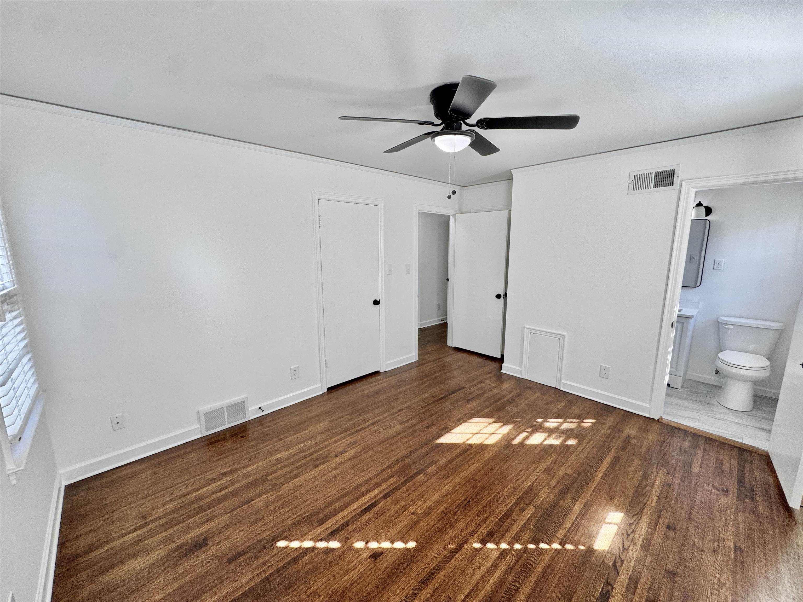 4417 Fair Meadow Road Memphis, TN 38117 - Photo 12 of 38 a view of a livingroom with wooden floor and a ceiling fan