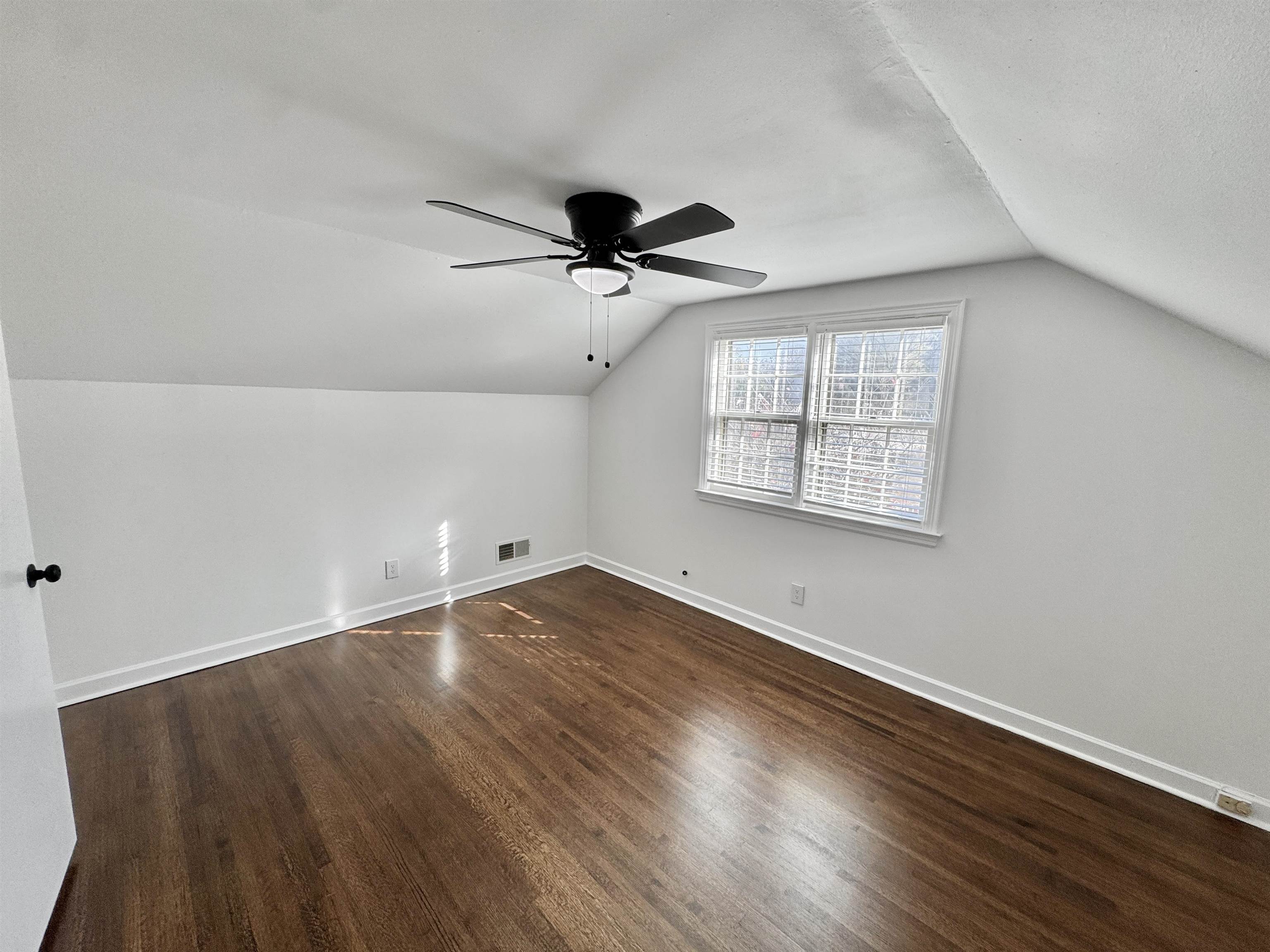 4417 Fair Meadow Road Memphis, TN 38117 - Photo 15 of 38 an empty room with wooden floor ceiling fan and windows