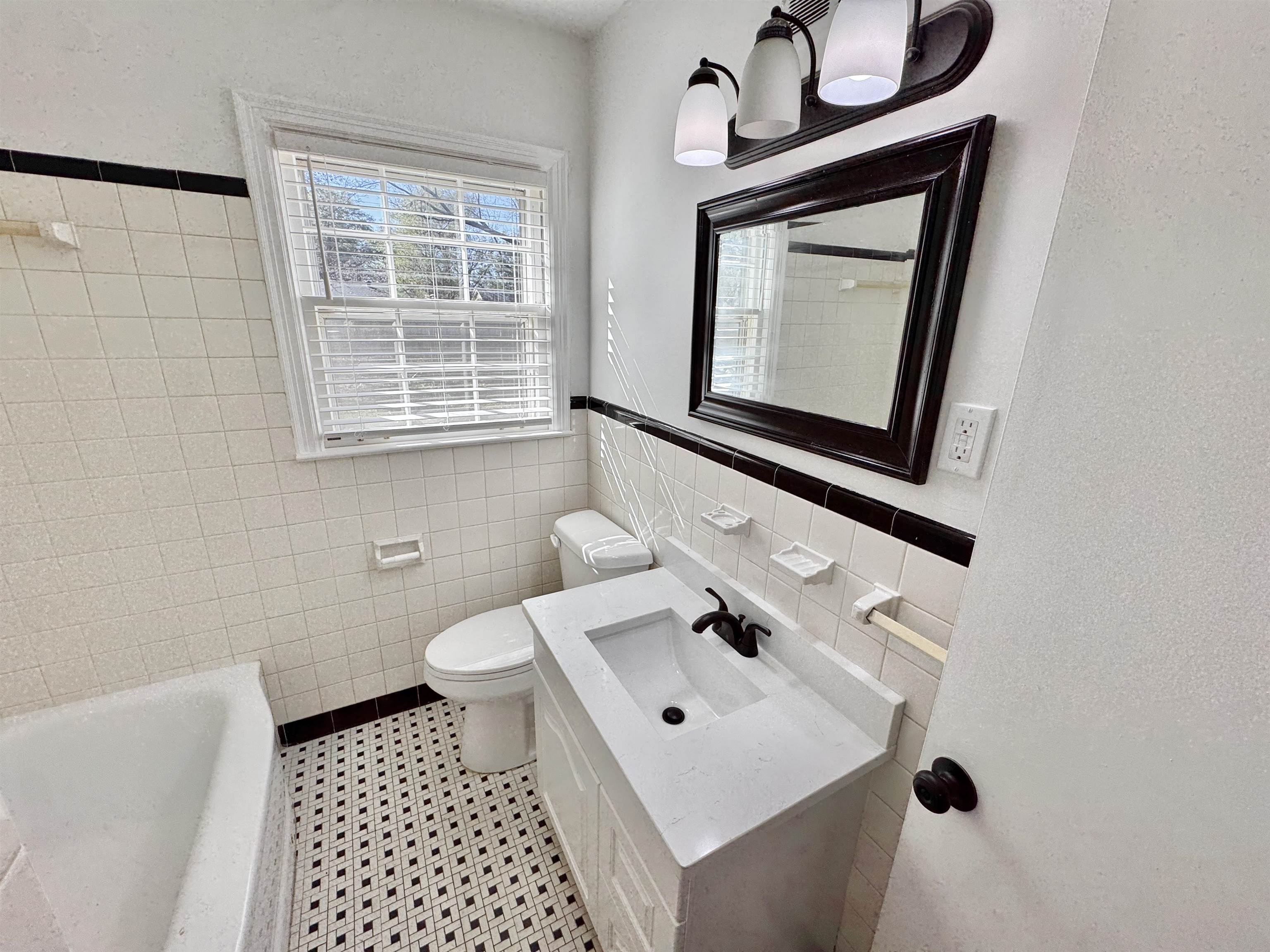 4417 Fair Meadow Road Memphis, TN 38117 - Photo 20 of 38 a bathroom with a sink toilet and mirror