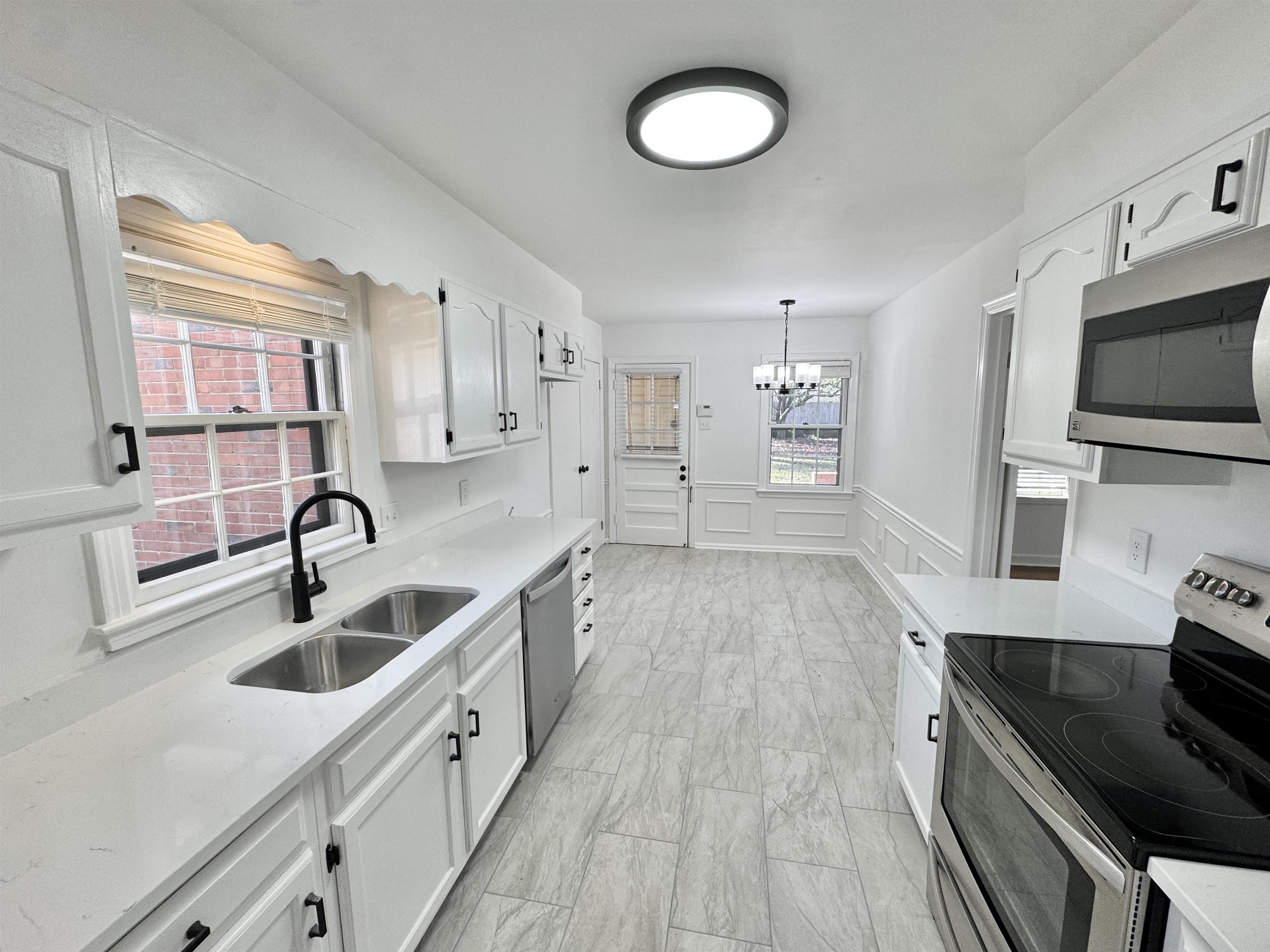 4417 Fair Meadow Road Memphis, TN 38117 - Photo 2 of 38 a kitchen with cabinets and a sink