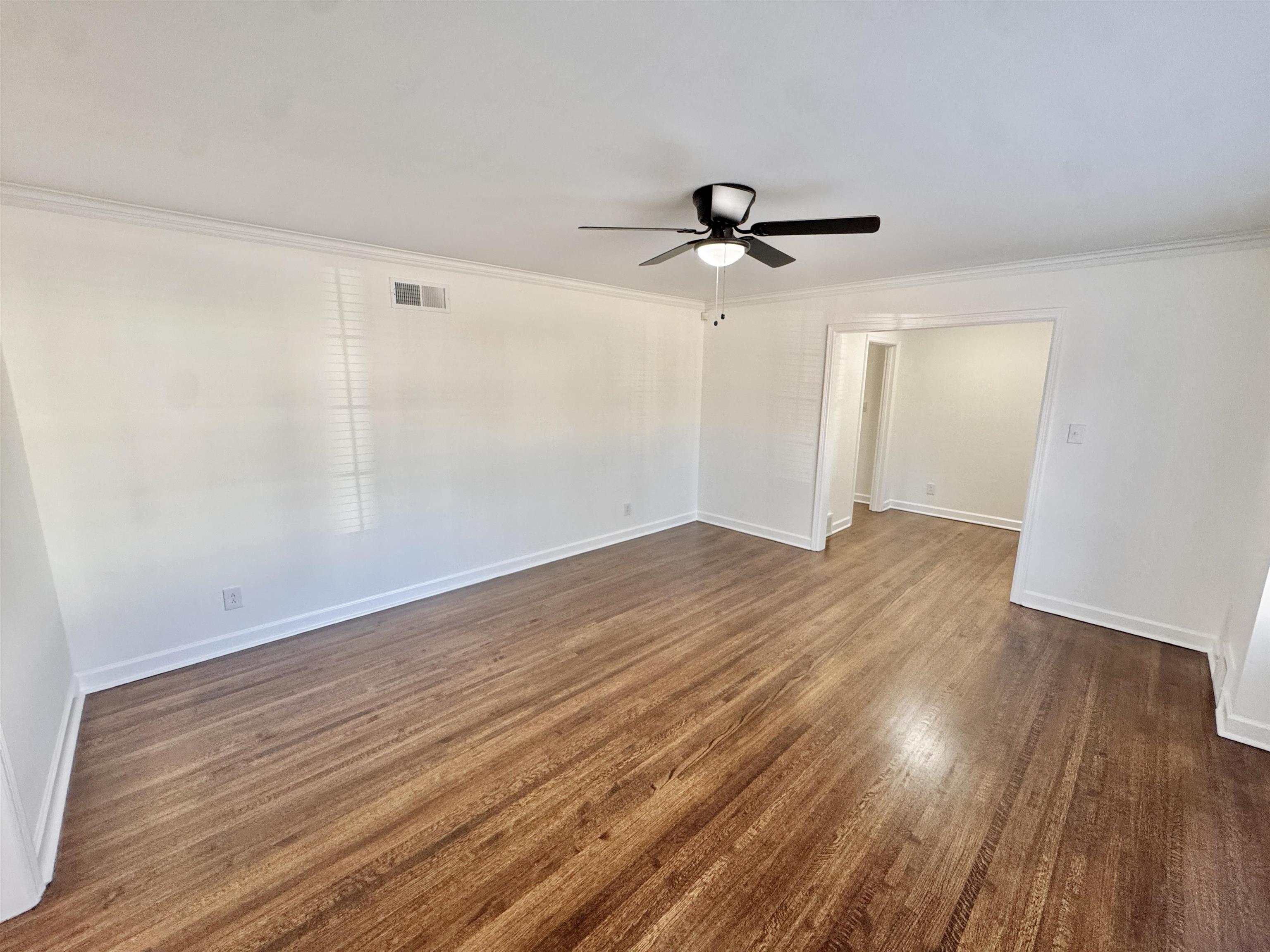 4417 Fair Meadow Road Memphis, TN 38117 - Photo 22 of 38 a view of a room with wooden floor ceiling fan and window