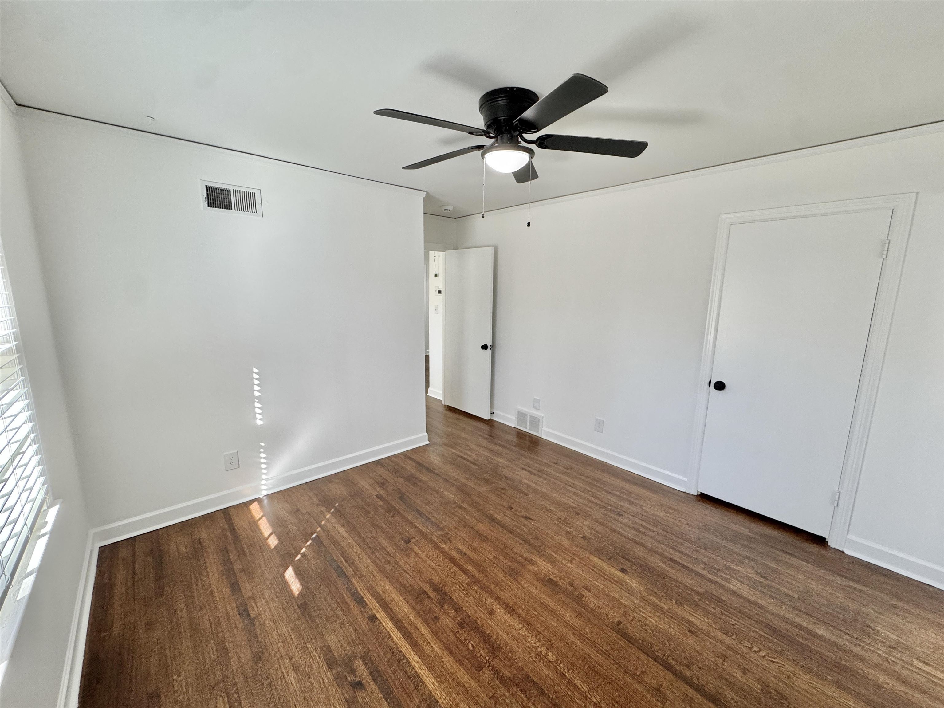 4417 Fair Meadow Road Memphis, TN 38117 - Photo 24 of 38 a view of empty room with wooden floor and fan