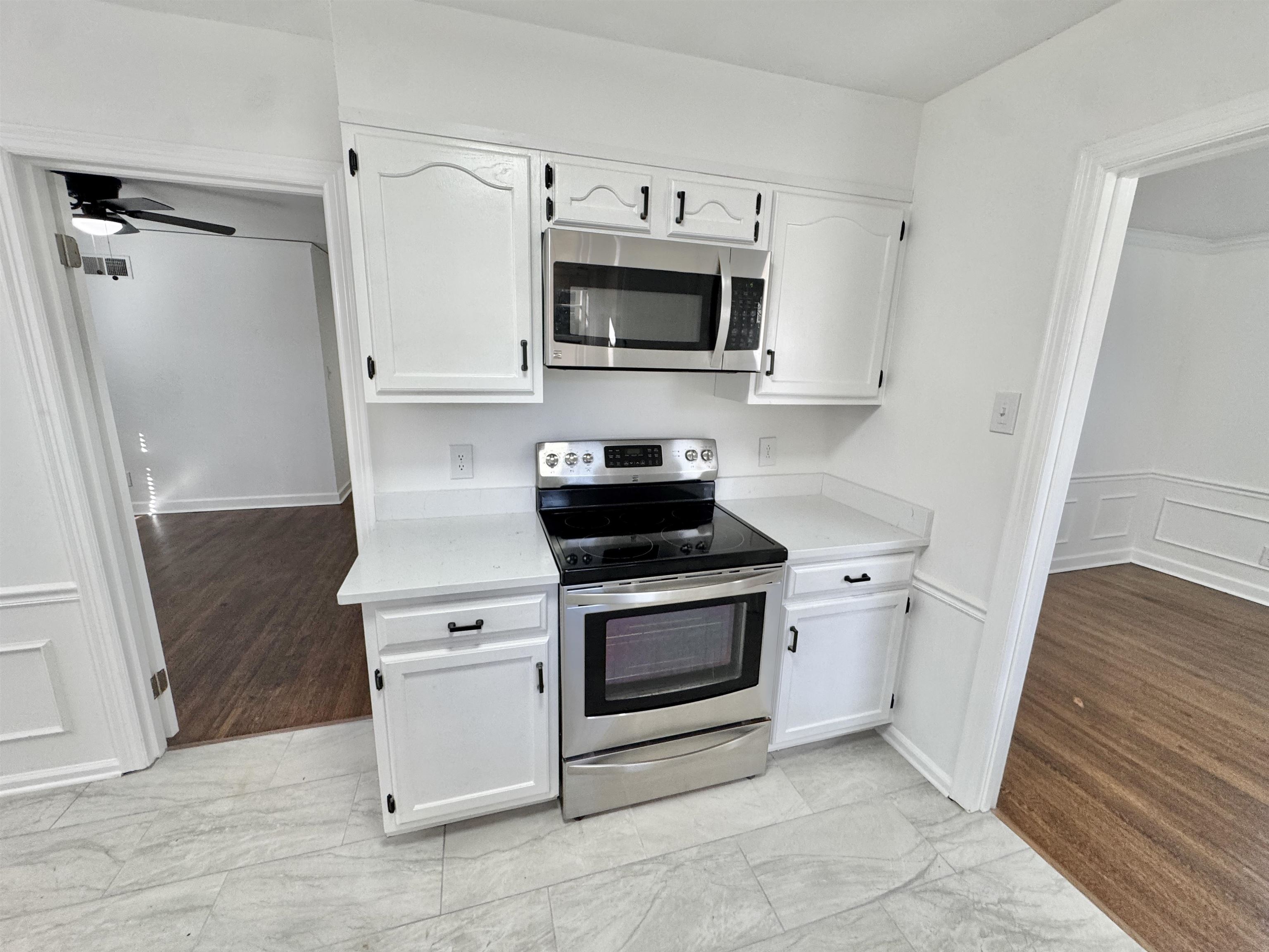 4417 Fair Meadow Road Memphis, TN 38117 - Photo 3 of 38 a kitchen with white cabinets and stainless steel appliances