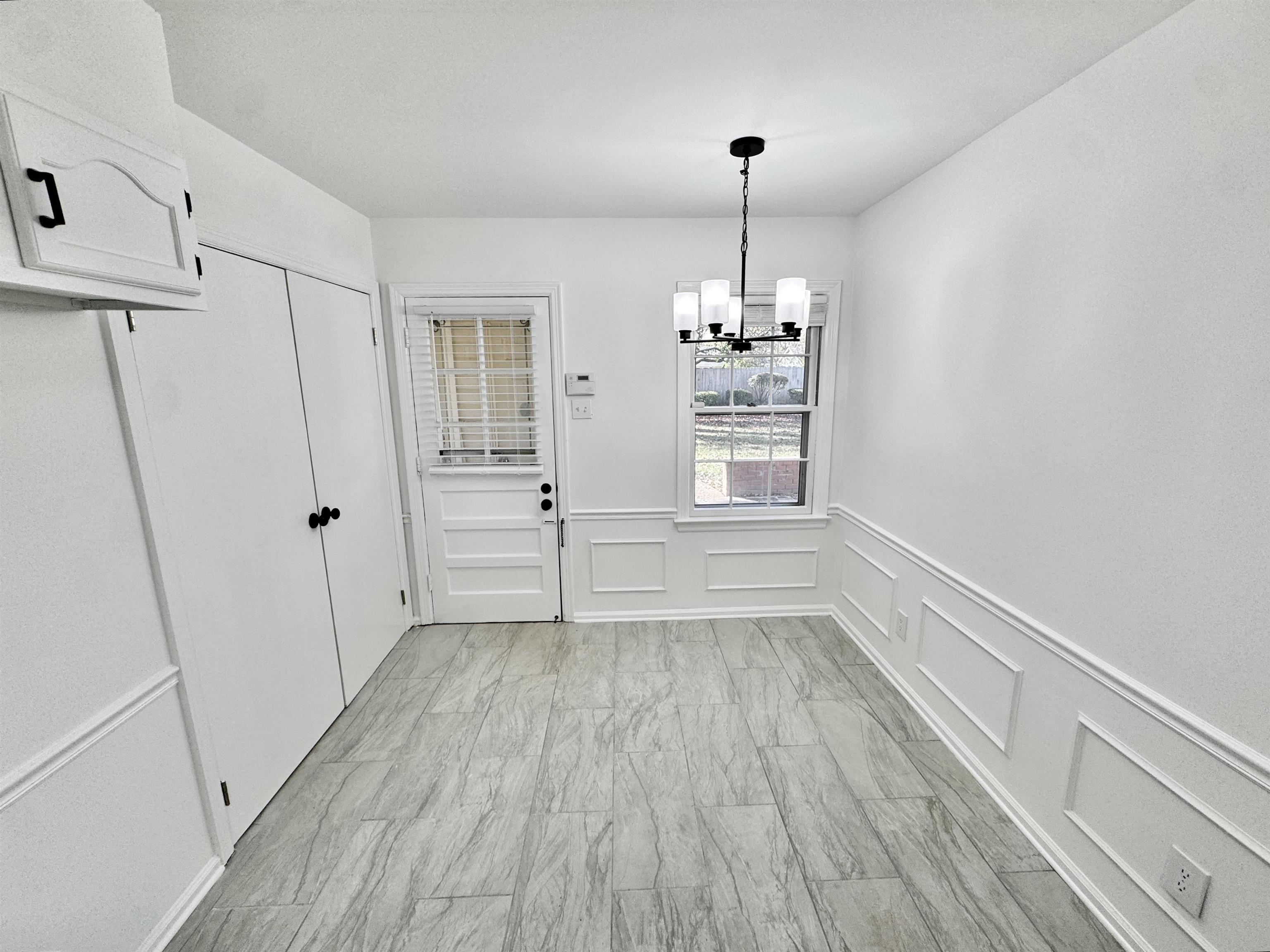 4417 Fair Meadow Road Memphis, TN 38117 - Photo 7 of 38 a view of empty room with wooden floor and window