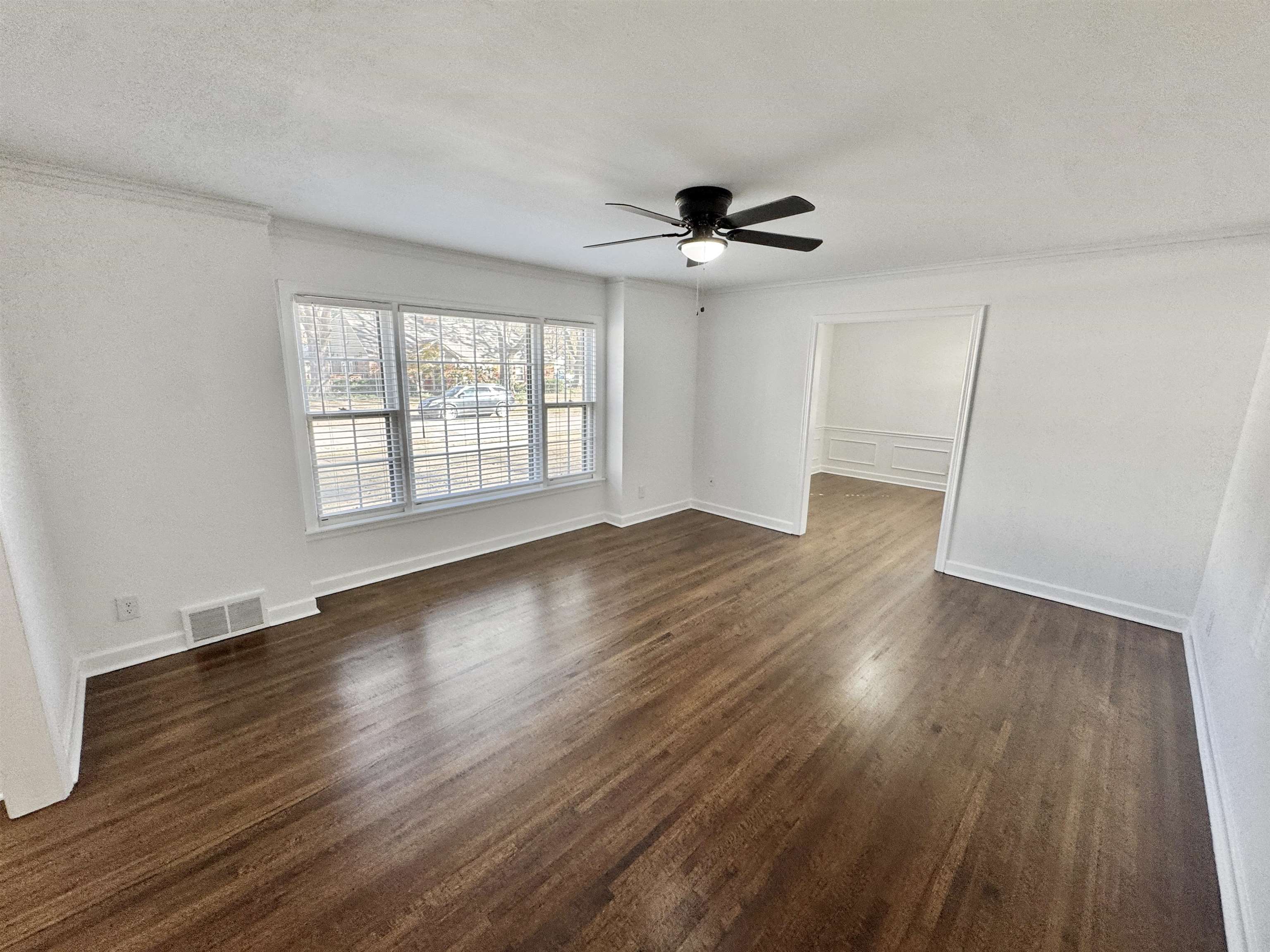 4417 Fair Meadow Road Memphis, TN 38117 - Photo 9 of 38 a view of an empty room with wooden floor and a window