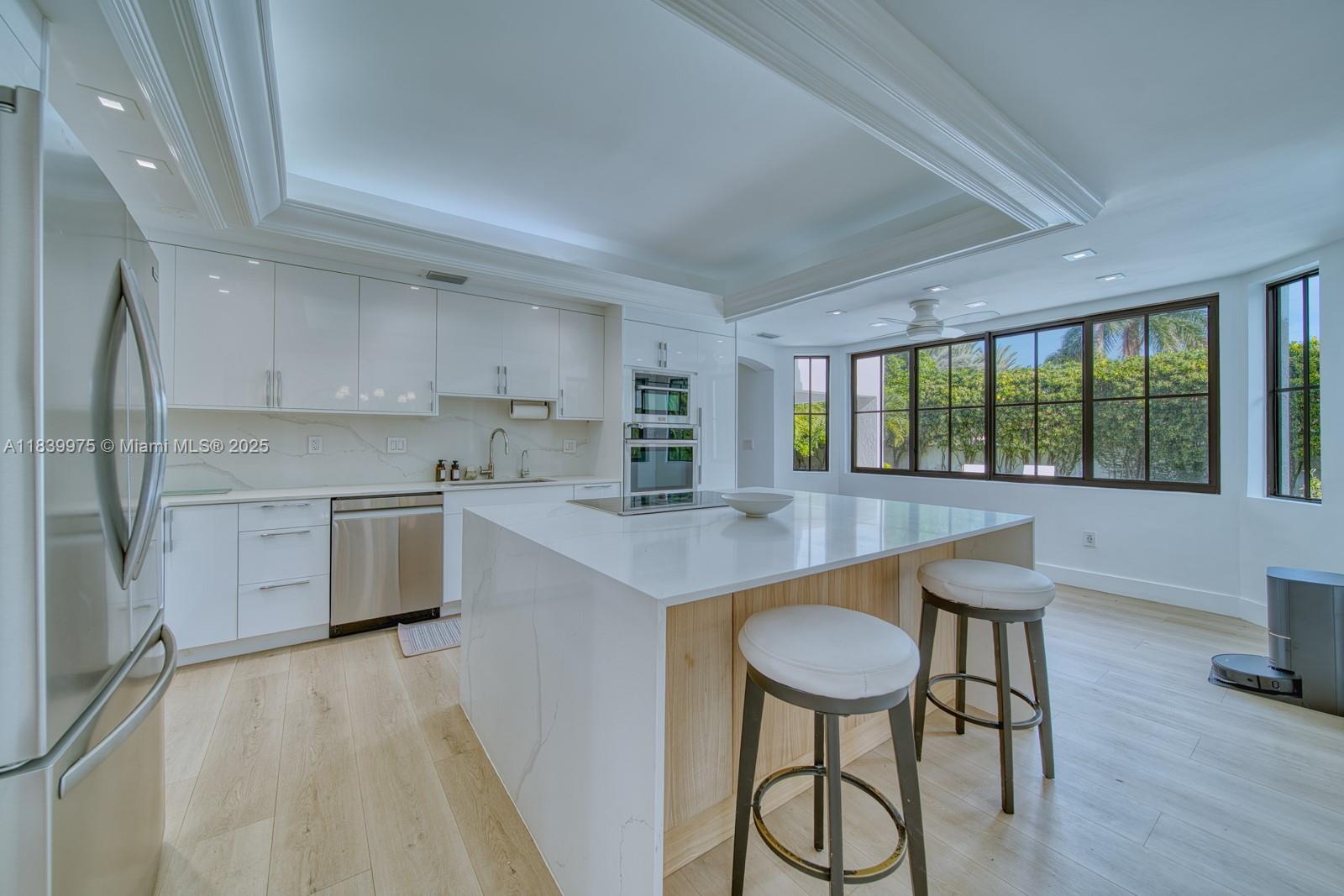 12480 Southwest 97th Street Miami, FL 33186 - Photo 21 of 64 a kitchen with a table chairs sink and cabinets