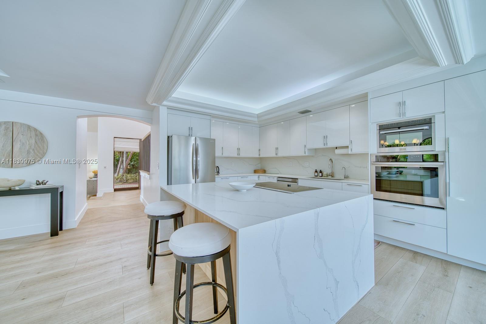 12480 Southwest 97th Street Miami, FL 33186 - Photo 22 of 64 a kitchen with a table chairs refrigerator and cabinets