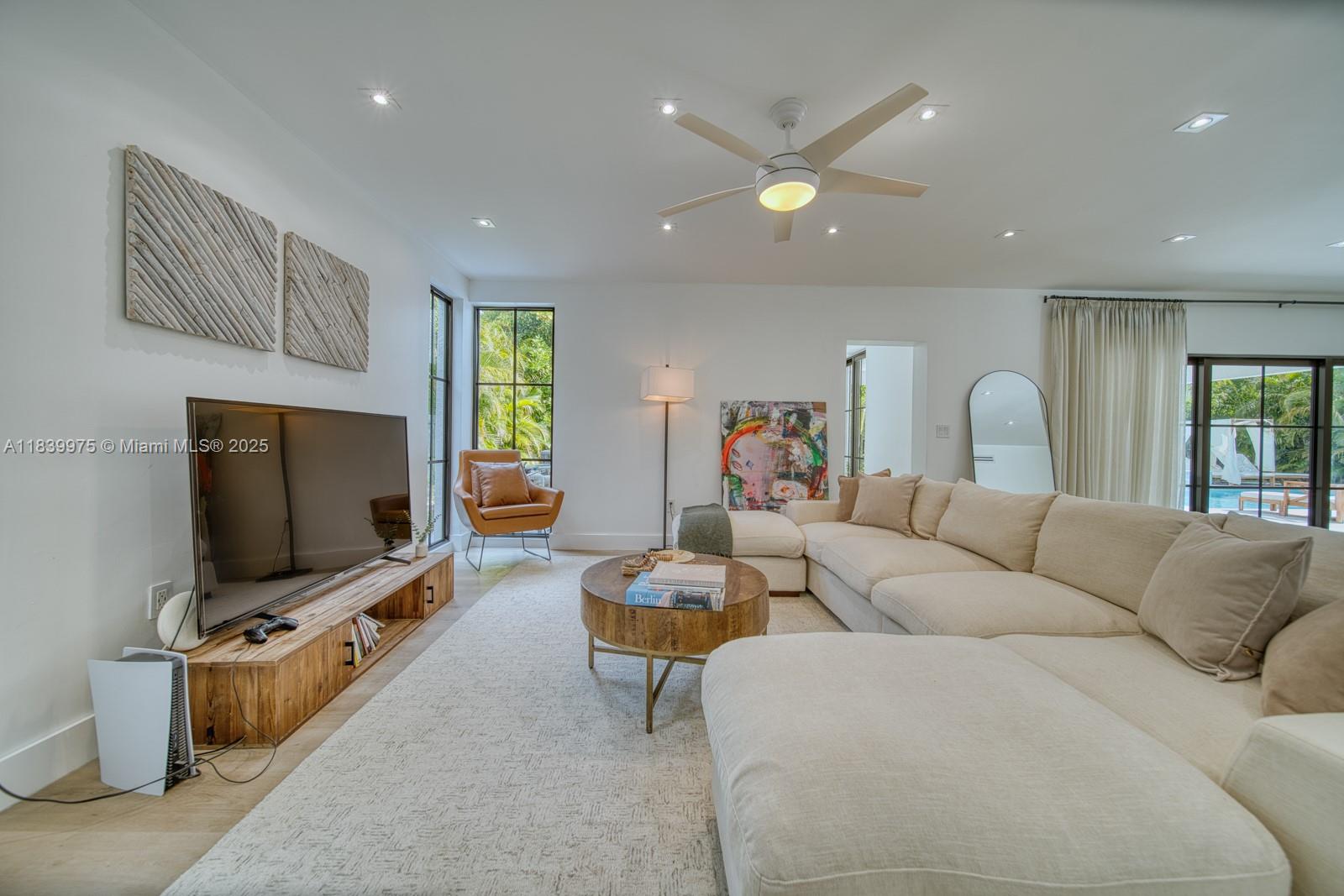 12480 Southwest 97th Street Miami, FL 33186 - Photo 25 of 64 a living room with furniture and a flat screen tv