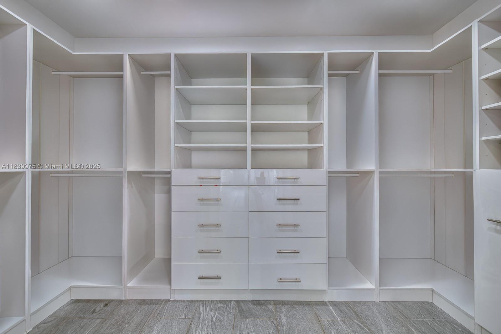 12480 Southwest 97th Street Miami, FL 33186 - Photo 38 of 64 a view of walk in closet with empty racks