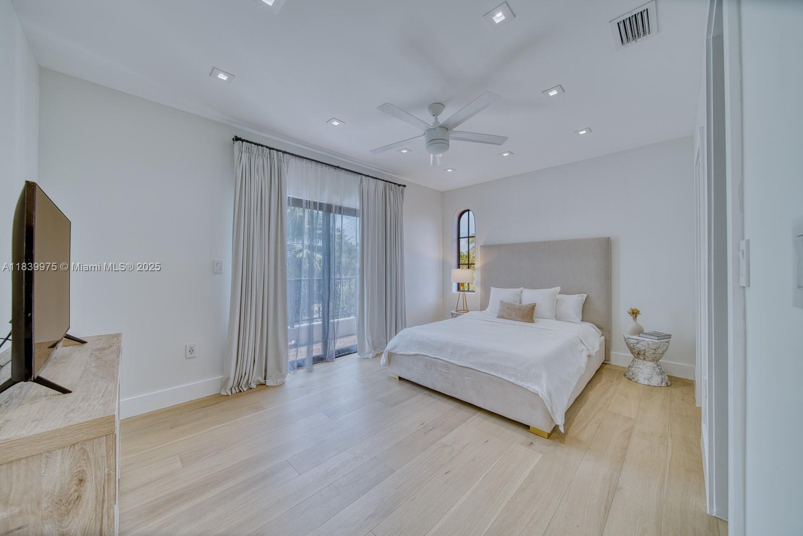 12480 Southwest 97th Street Miami, FL 33186 - Photo 44 of 64 a bedroom with a large bed and a flat tv screen on dresser