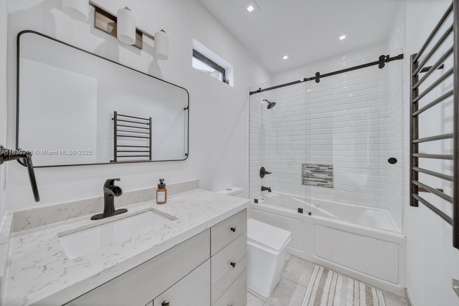 12480 Southwest 97th Street Miami, FL 33186 - Photo 45 of 64 a bathroom with a tub sink mirror and shower