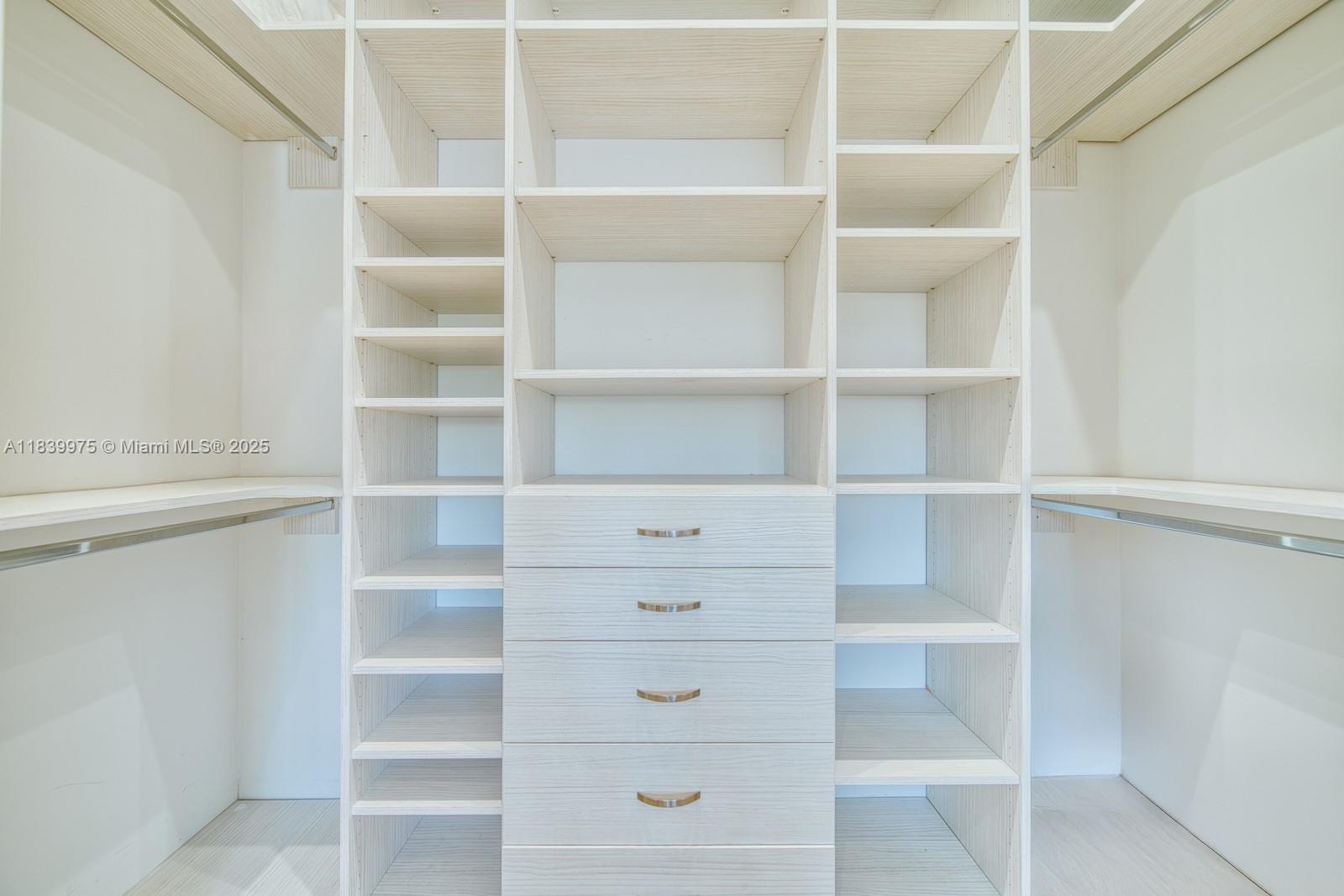 12480 Southwest 97th Street Miami, FL 33186 - Photo 46 of 64 a view of walk in closet with empty racks