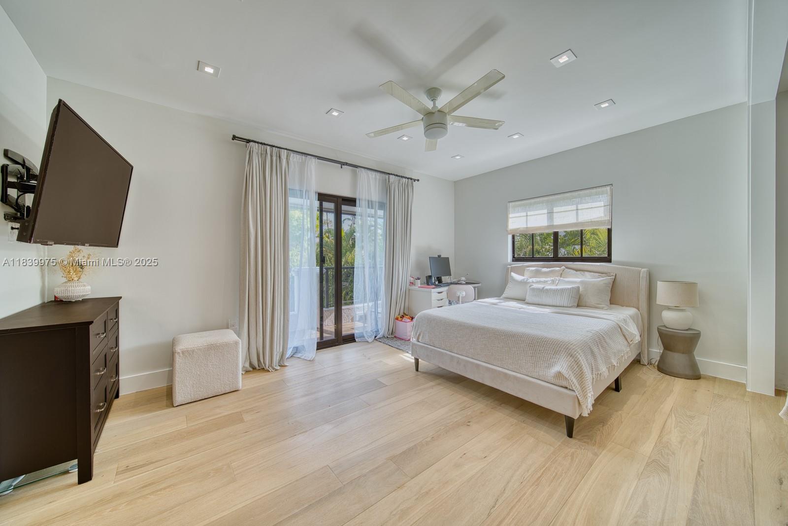 12480 Southwest 97th Street Miami, FL 33186 - Photo 47 of 64 a spacious bedroom with a large bed and a flat screen tv