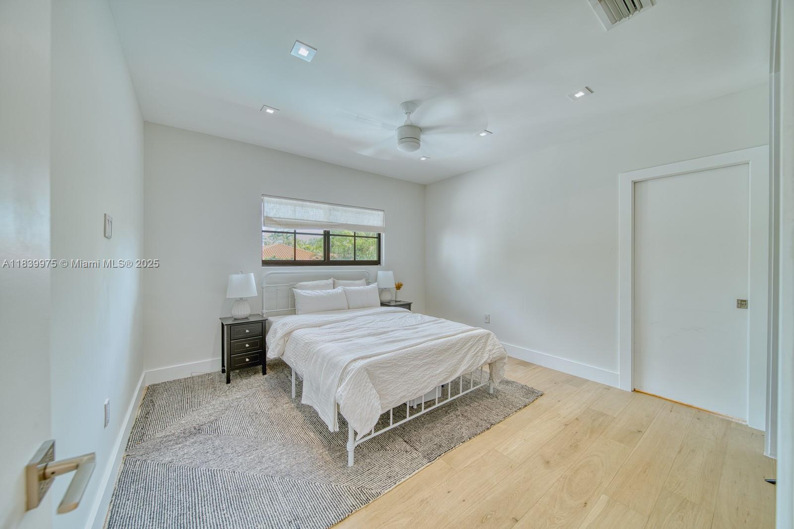 12480 Southwest 97th Street Miami, FL 33186 - Photo 49 of 64 a bedroom with a bed and a night stand