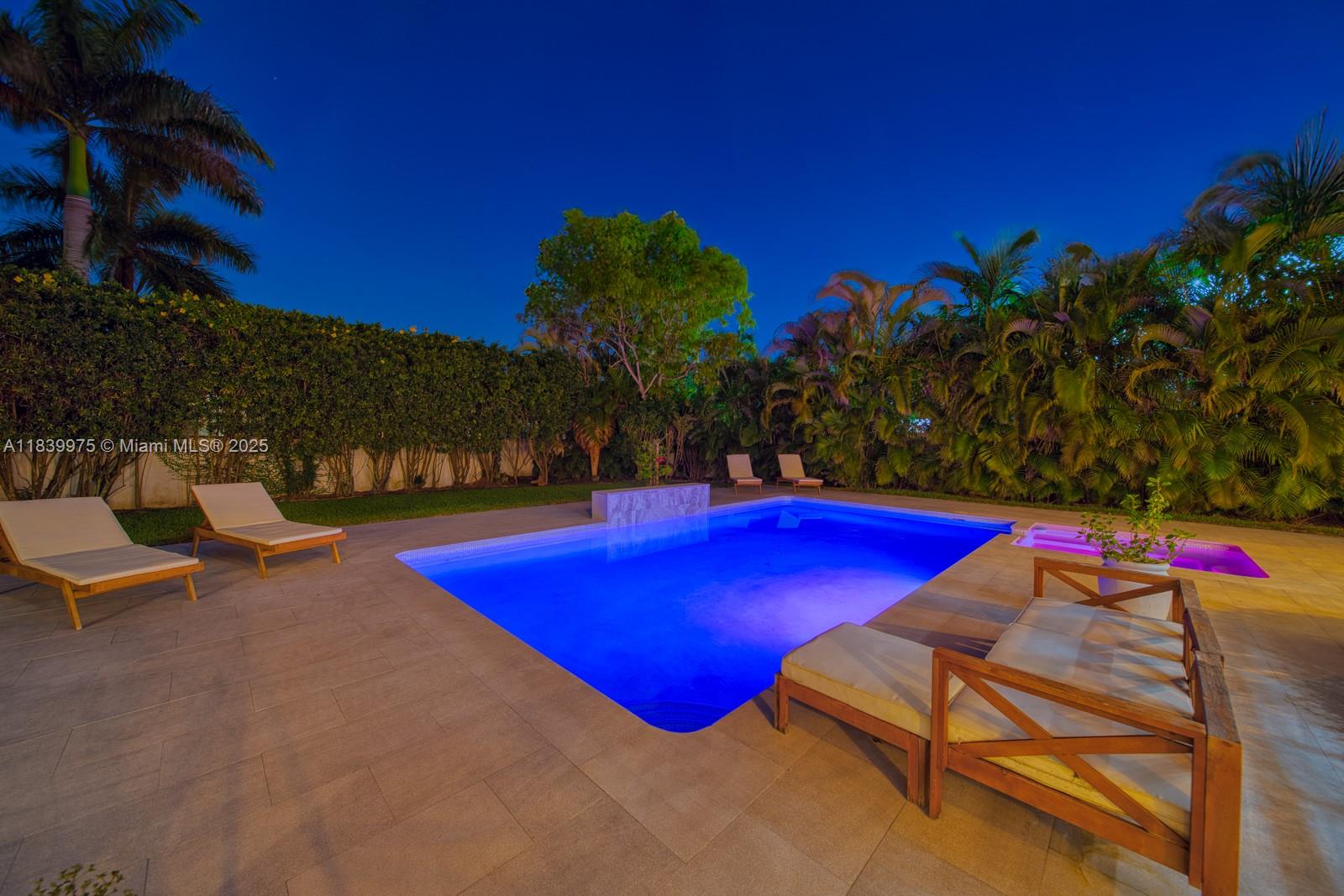 12480 Southwest 97th Street Miami, FL 33186 - Photo 5 of 64 a view of a pool with lawn chairs under an umbrella