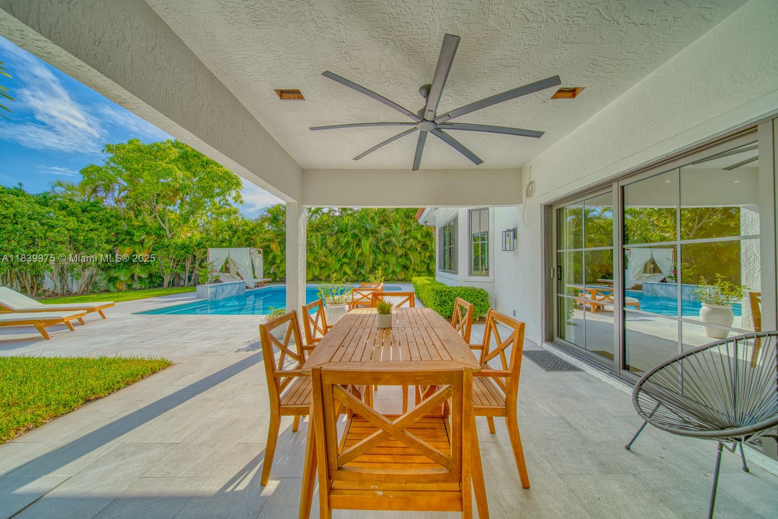 12480 Southwest 97th Street Miami, FL 33186 - Photo 60 of 64 a view of a patio with a table chairs and a backyard
