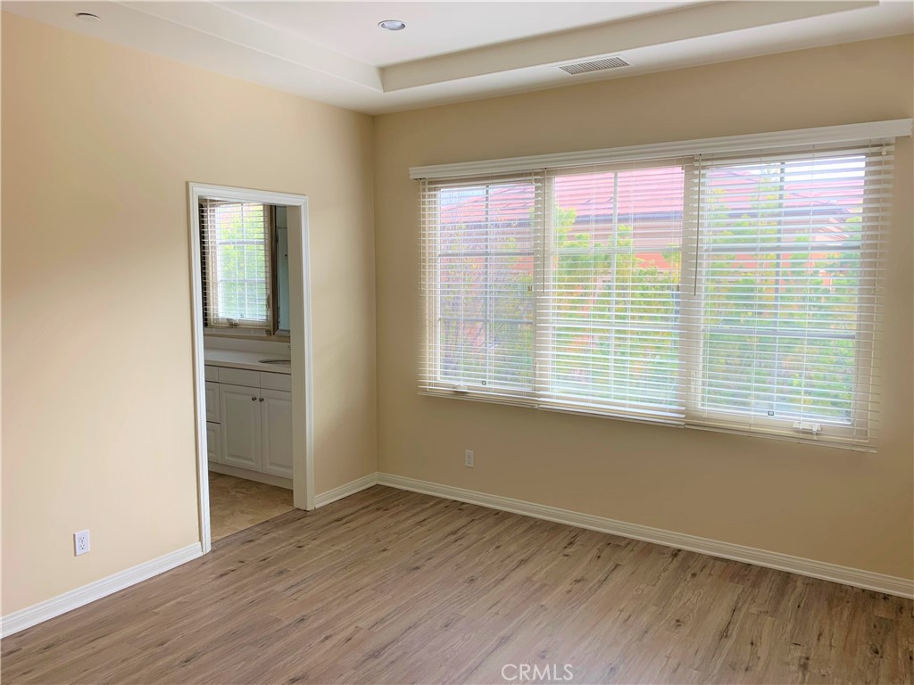 36 Brindisi Irvine, CA 92618 - Photo 11 of 44 a view of an empty room with wooden floor and a window