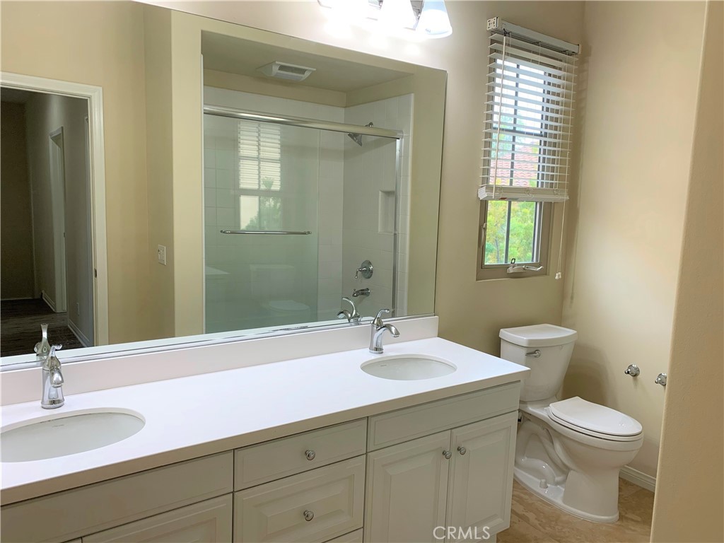 36 Brindisi Irvine, CA 92618 - Photo 18 of 44 a bathroom with a sink and a mirror