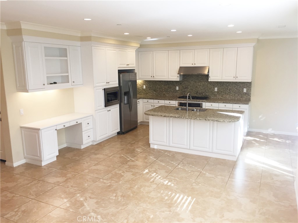 36 Brindisi Irvine, CA 92618 - Photo 2 of 44 a kitchen with stainless steel appliances granite countertop a sink stove and refrigerator
