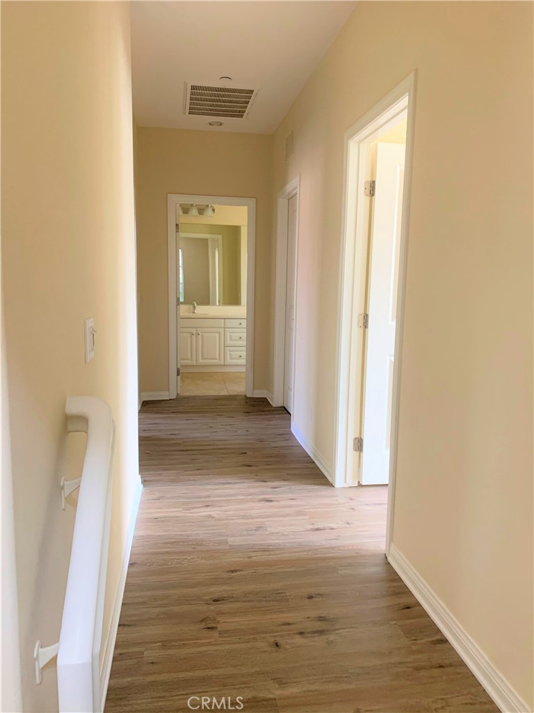 36 Brindisi Irvine, CA 92618 - Photo 9 of 44 a view of a hallway with wooden floor