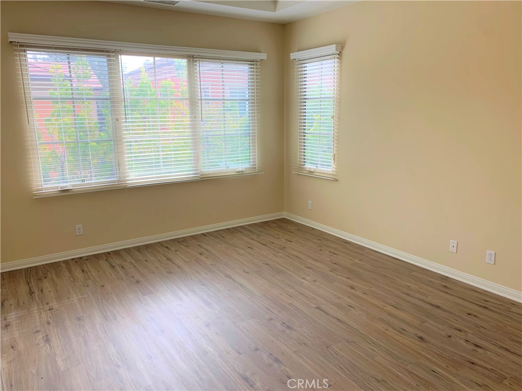 36 Brindisi Irvine, CA 92618 - Photo 10 of 44 an empty room with wooden floor and windows