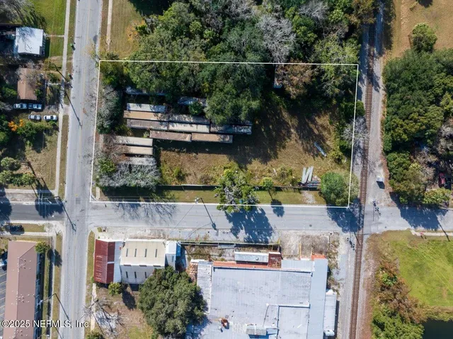 an aerial view of a house with a yard