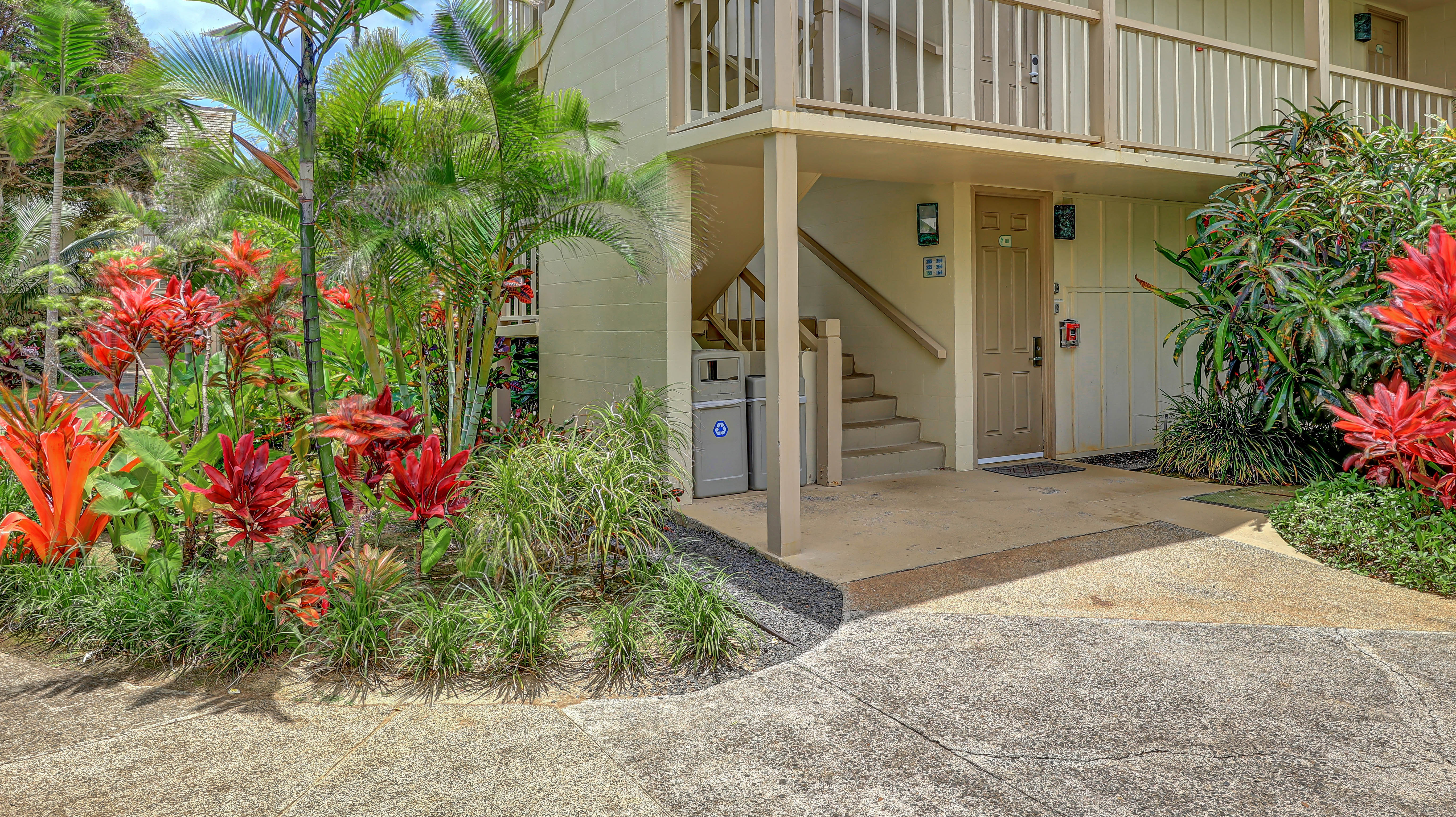 440 Aleka Place, Unit 256 Kapaa, HI 96746 - Photo 27 of 27 a front view of a house with lots of flower plants