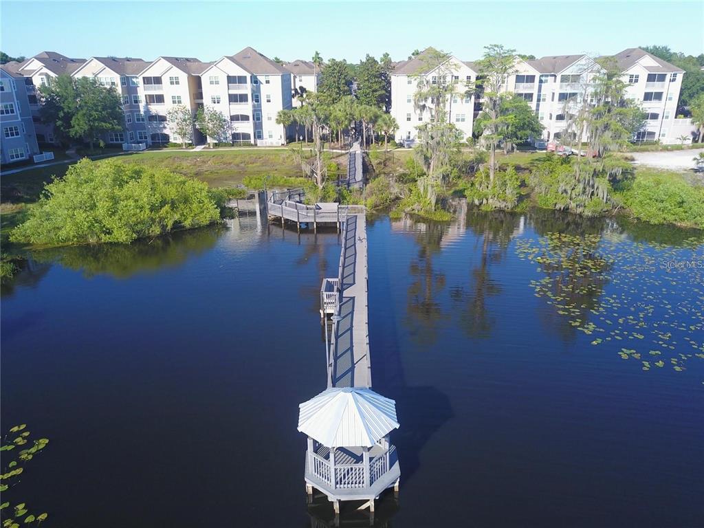 3280 Soho Street, Unit 307 Orlando, FL 32835 - Photo 25 of 34 a swimming pool in middle of the green building