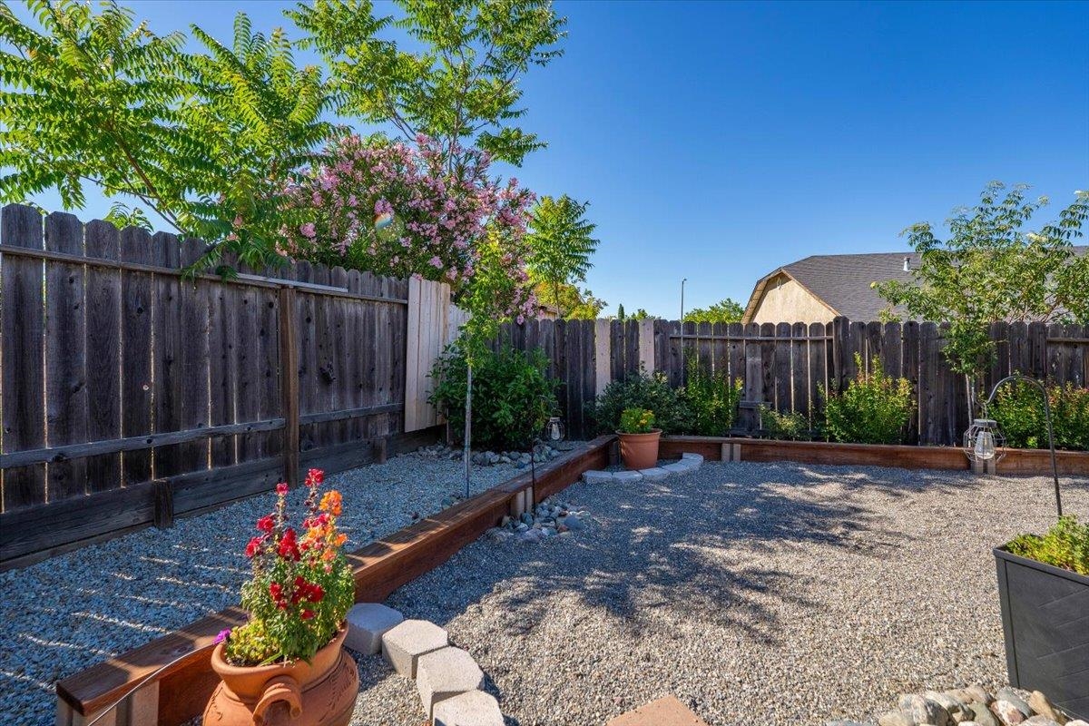 2110 Gentry Way Red Bluff, CA 96080 - Photo 37 of 47 a garden with flowers in front of it