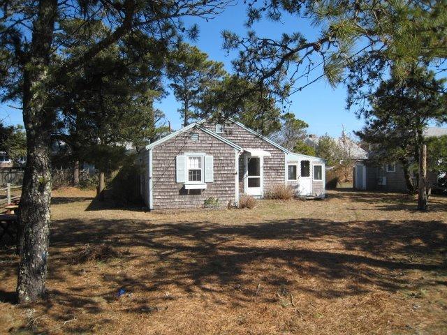 84 Uncle Rolf Road Dennis Port, MA 02639 - Photo 2 of 16 a front view of a house with a yard