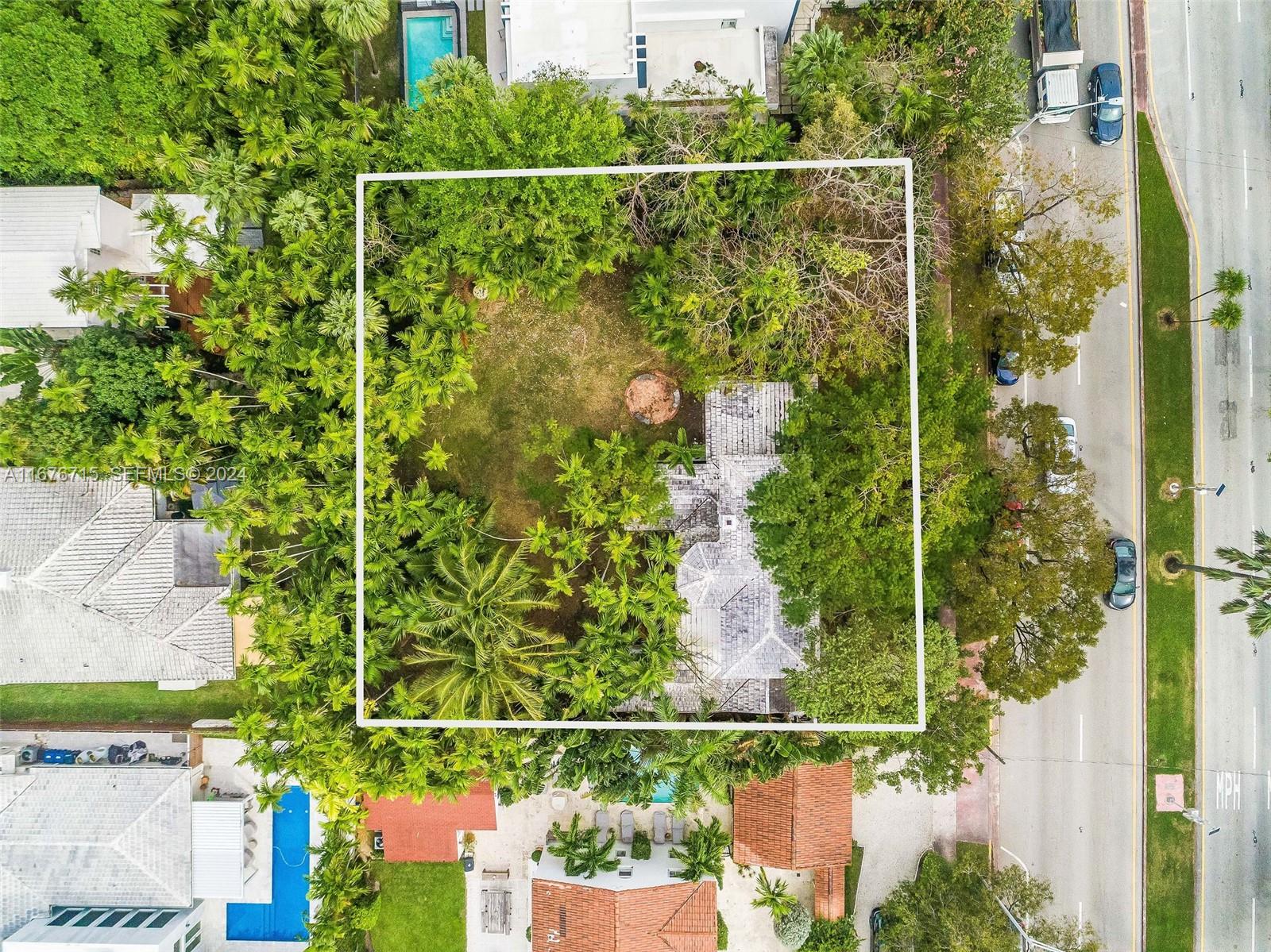 6080 Alton Road Miami Beach, FL 33140 - Photo 10 of 11 a view of a fence and a garden