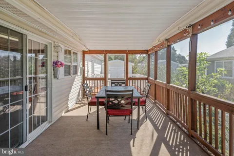 a living room with furniture a table and a large window