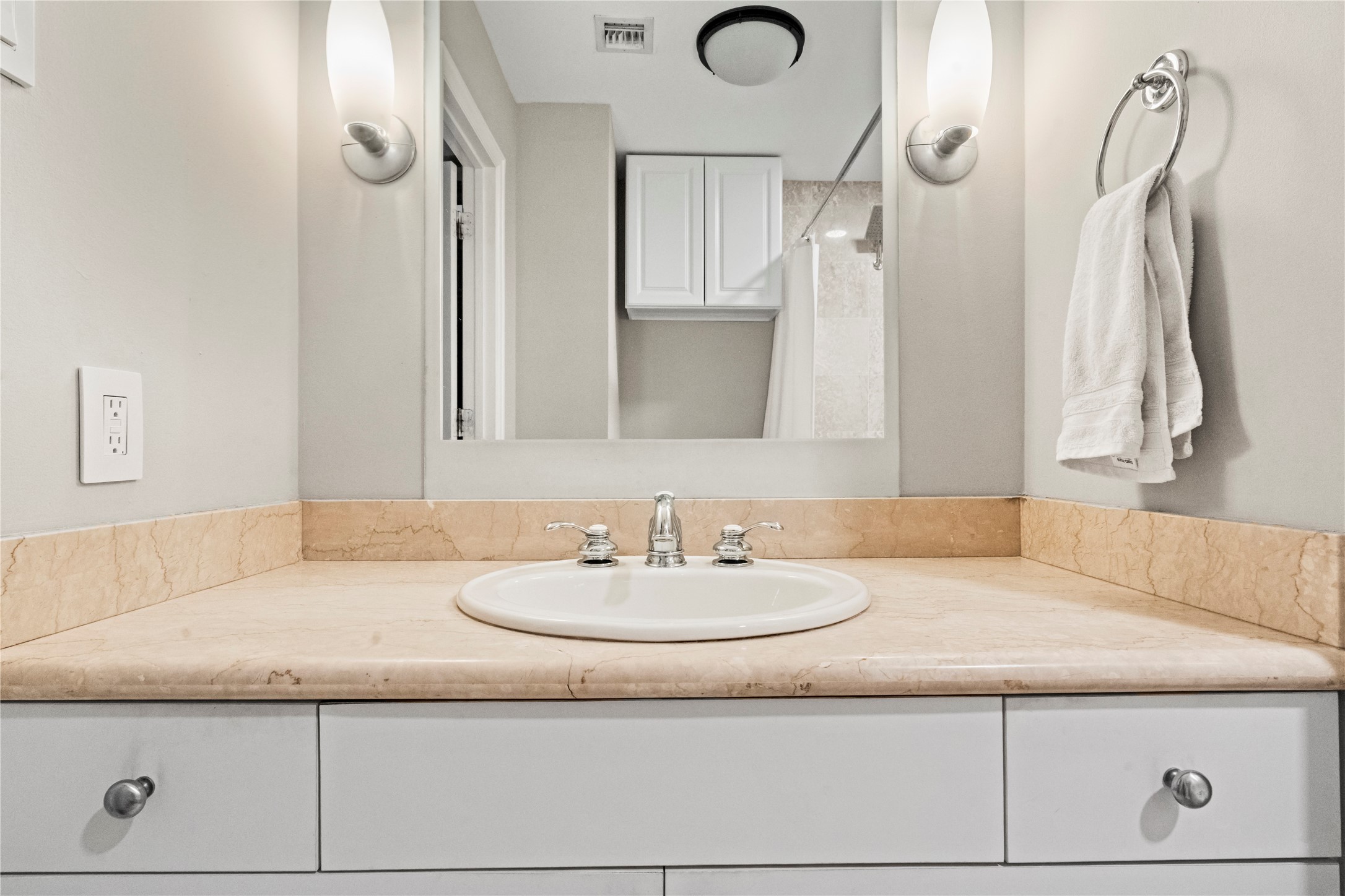 915 Franklin Street, Unit 8J Houston, TX 77002 - Photo 7 of 12 a bathroom with a granite countertop sink and a mirror