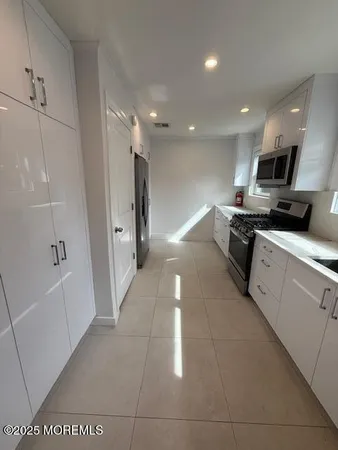 a kitchen with stainless steel appliances a refrigerator and a sink