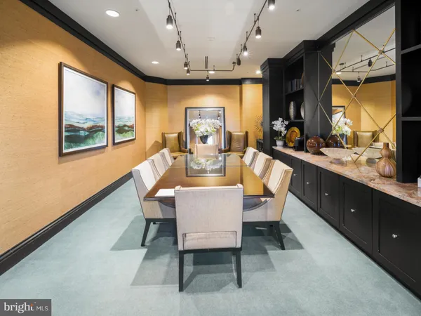 a view of a dining room with furniture a chandelier and wooden floor