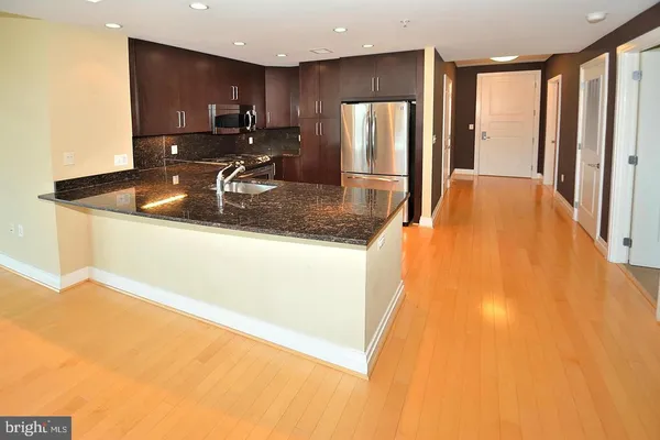 a kitchen with stainless steel appliances a refrigerator and a sink