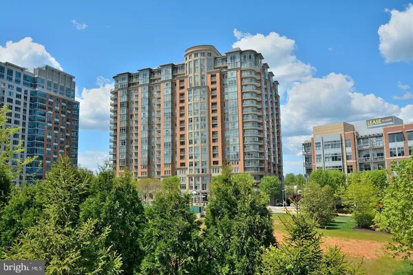a view of a building with garden and patio