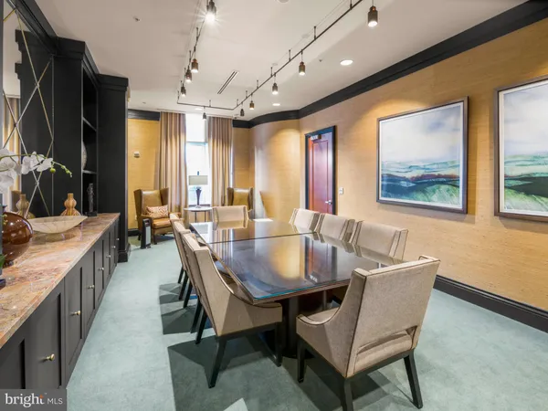 a dining room with furniture a window and a chandelier