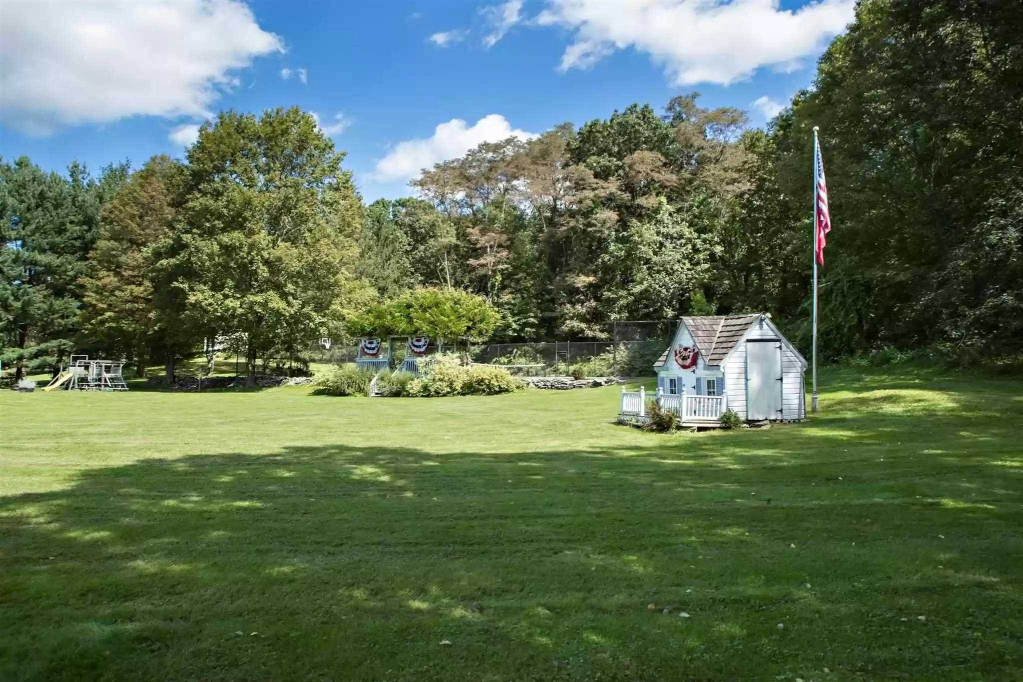 20 Barmore Road LaGrange, NY 12540 - Photo 29 of 32 a white house with a big yard and large trees with wooden fence