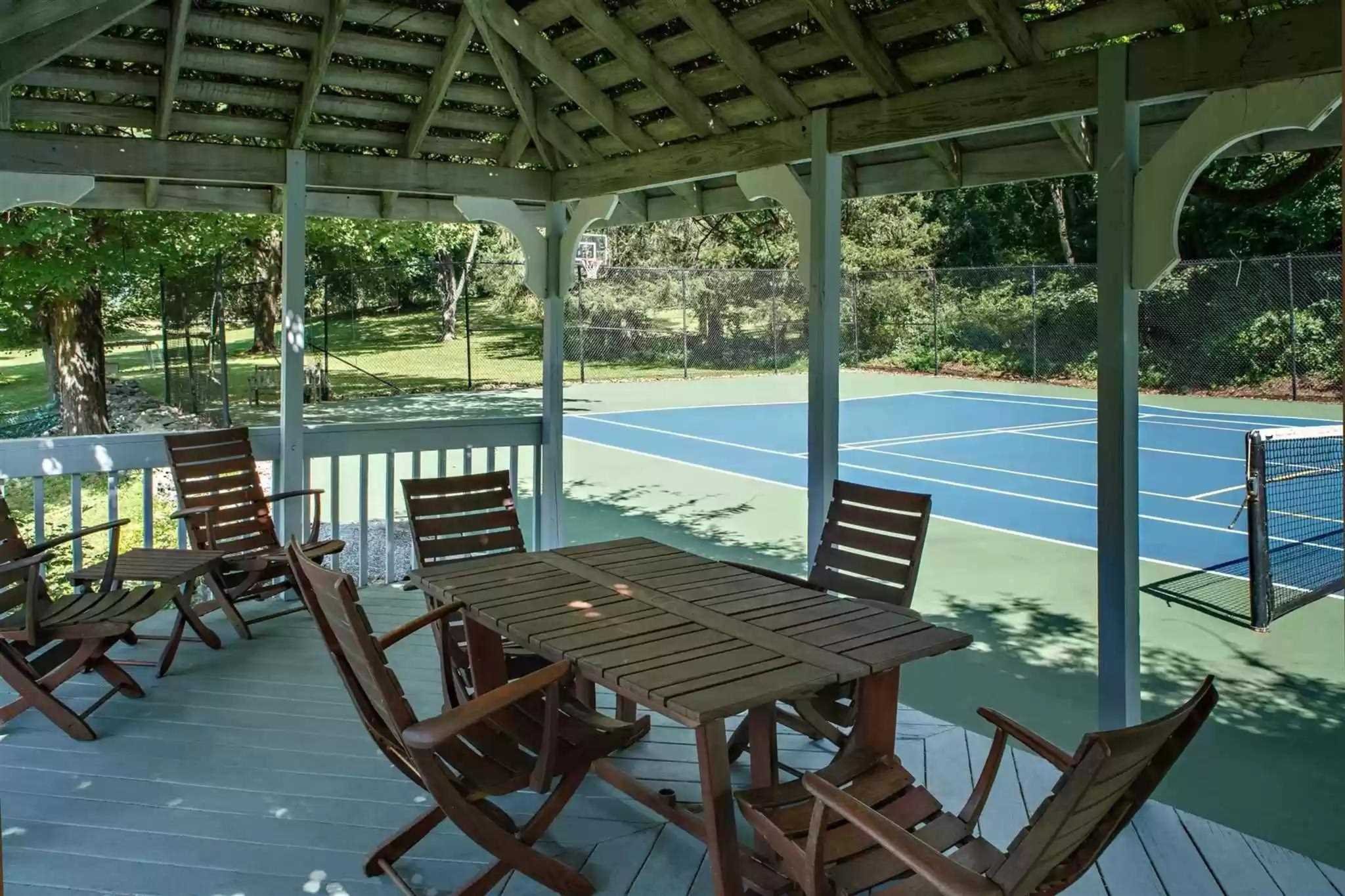 20 Barmore Road LaGrange, NY 12540 - Photo 30 of 32 a view of a patio with table and chairs and wooden floor next to a yard