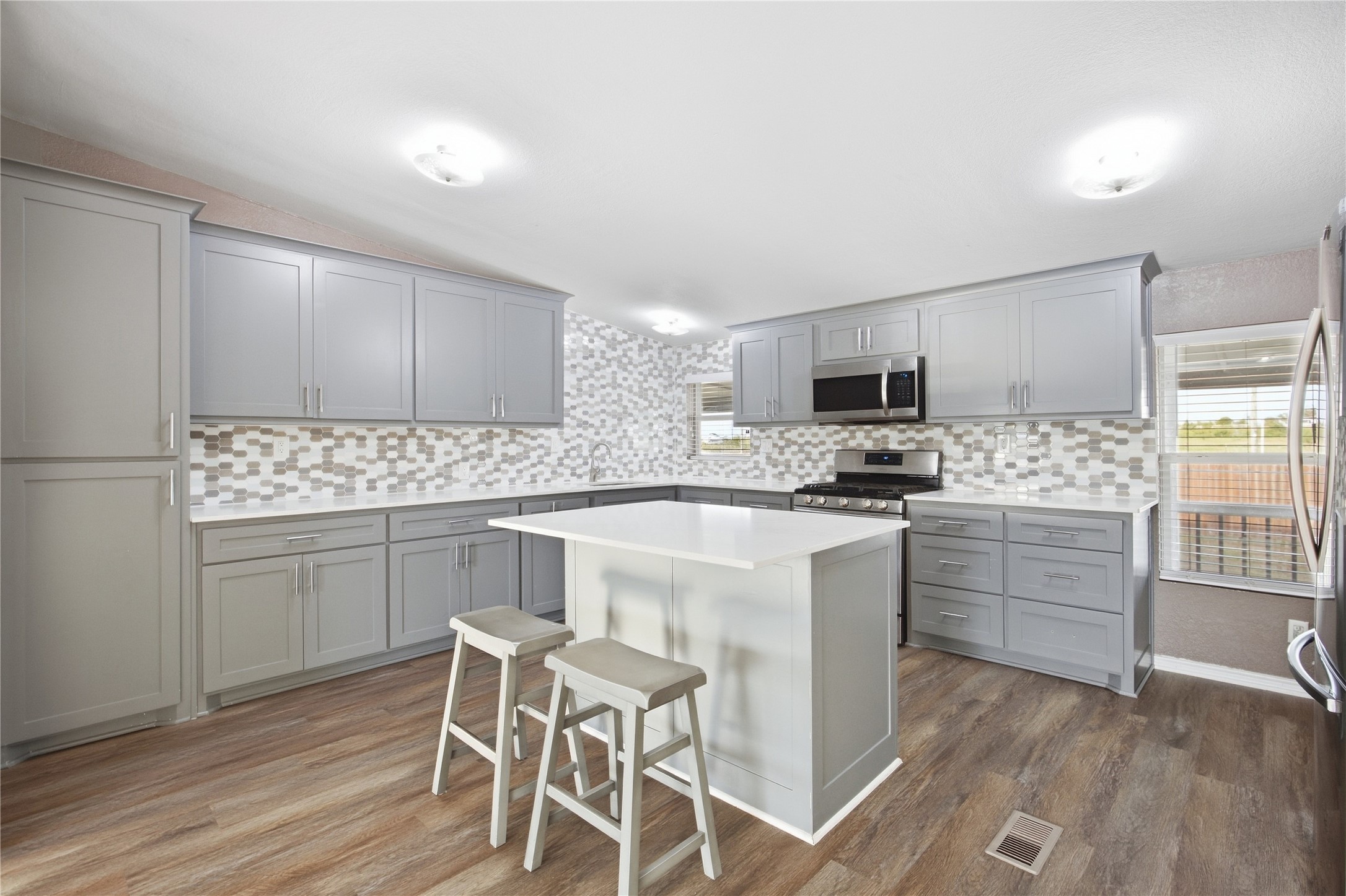 2709 County Road 463 Elgin, TX 78621 - Photo 8 of 32 Modern cabinetry and a central island highlight this beautifully updated culinary space.