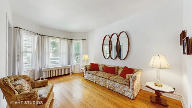 a living room with furniture flowerpot and window