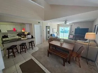a car parked in front of a house with wooden fence