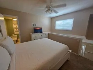 a kitchen with a dining table chairs and white cabinets