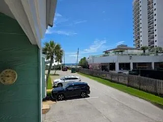 a living room with furniture a flat screen tv and a large window
