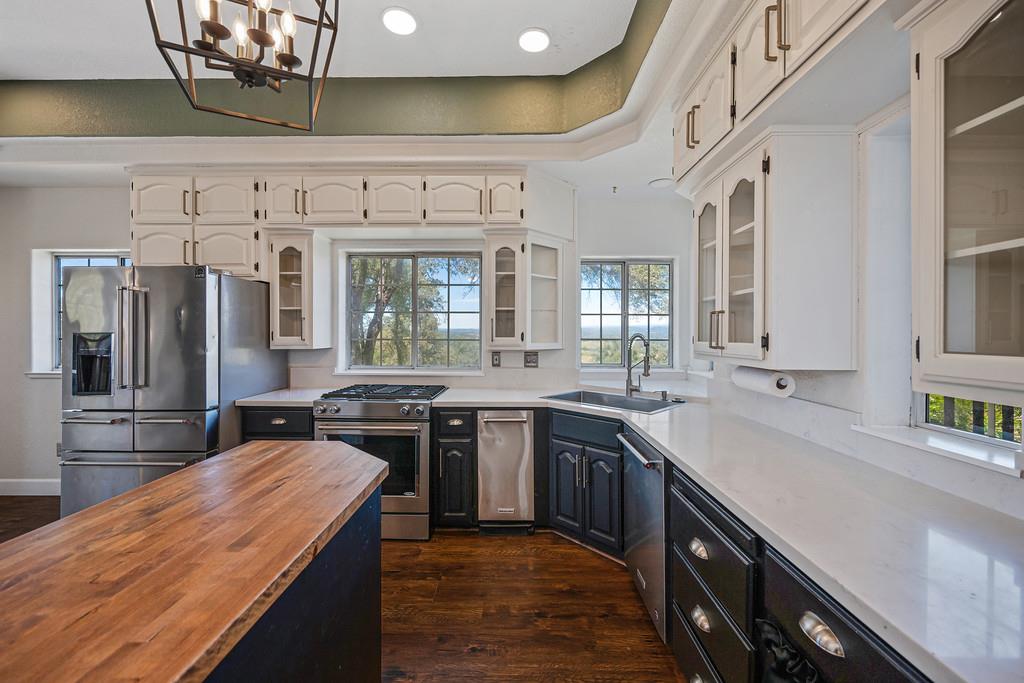 3154 Twin K Road Pilot Hill, CA 95664 - Photo 41 of 89 a kitchen with stainless steel appliances granite countertop a sink a stove and cabinets