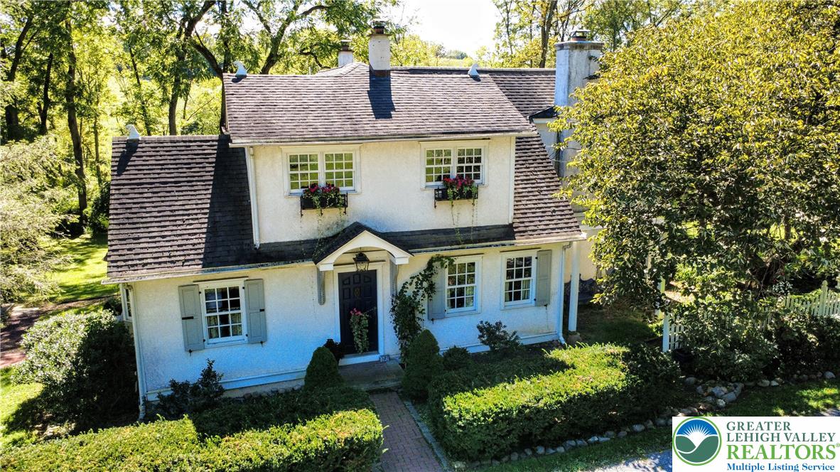1731 Howell Road Easton, PA 18040 - Photo 1 of 60 Mature trees and neat hedges frame this classic stucco exterior with traditional multi-pane windows.