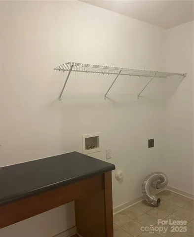 a view of storage and utility room with racks on the wall