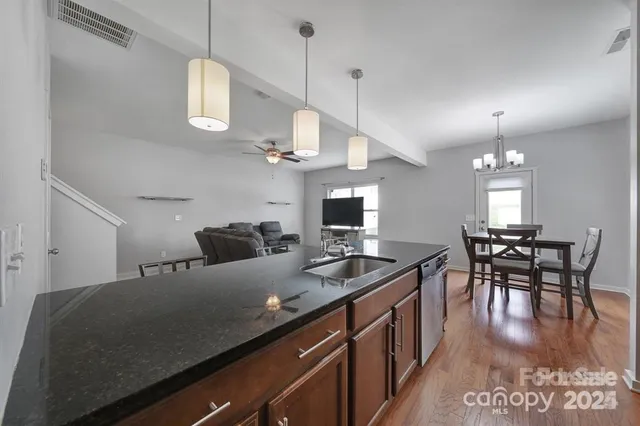 a kitchen with cabinets table and chairs
