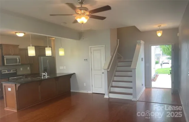 a view of a hallway with entryway window and wooden floor
